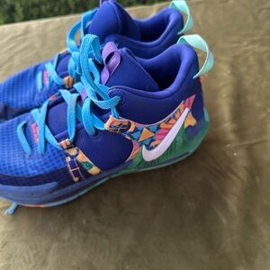 These are Nike LeBron Witness 7 basketball shoes in the "Kaleidoscope" colorway